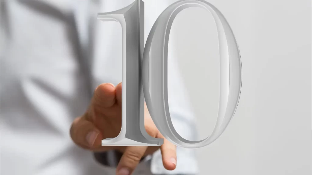 איש עסקים בחולצה לבנה מושיט ידו לספרה 10 ורטואלית במרחב